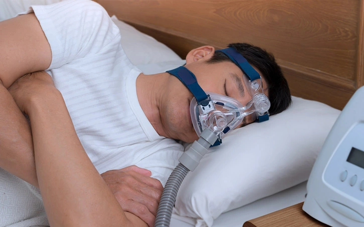 Brooklyn dentist examining a patient's jaw before a sleep apnea consultation