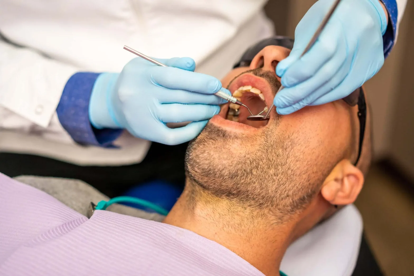 Emergency dentist in Brooklyn examining a patient with a cracked tooth