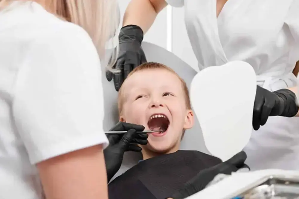 Toddler smiling during first dental checkup at Trump Village Dental in Brooklyn NY